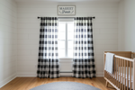 Nursery with black and white checkered curtains and a crib.