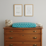 Arrow in Teal Western Changing Pad Cover on Brown Dresser with Wall Art