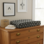 Black Arrow Western Changing Pad Cover on Brown Dresser with Wall Art