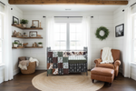 Bright farmhouse nursery with cactus mountains and cow minky western bedding
