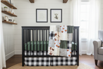 Close-up highland cow nursery with hunter green and buffalo check