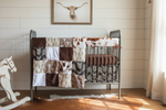 Close-up of western crib bedding in rustic nursery