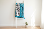 Black White Cow Minky and Mallard Galaxy Minky Farm Ruffle Blanket on white blanket ladder