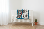 Cream Aztec and Brownie Calf Minky Western Ruffle Blanket draped over white crib rail
